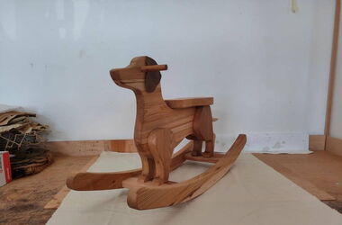 Close-up of a children's swing shaped like a dachshund.